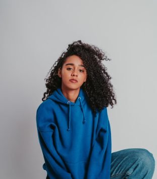 beautiful-curly-haired-girl-posing-in-a-blue-sweat-2025-02-11-23-55-44-utc.jpeg